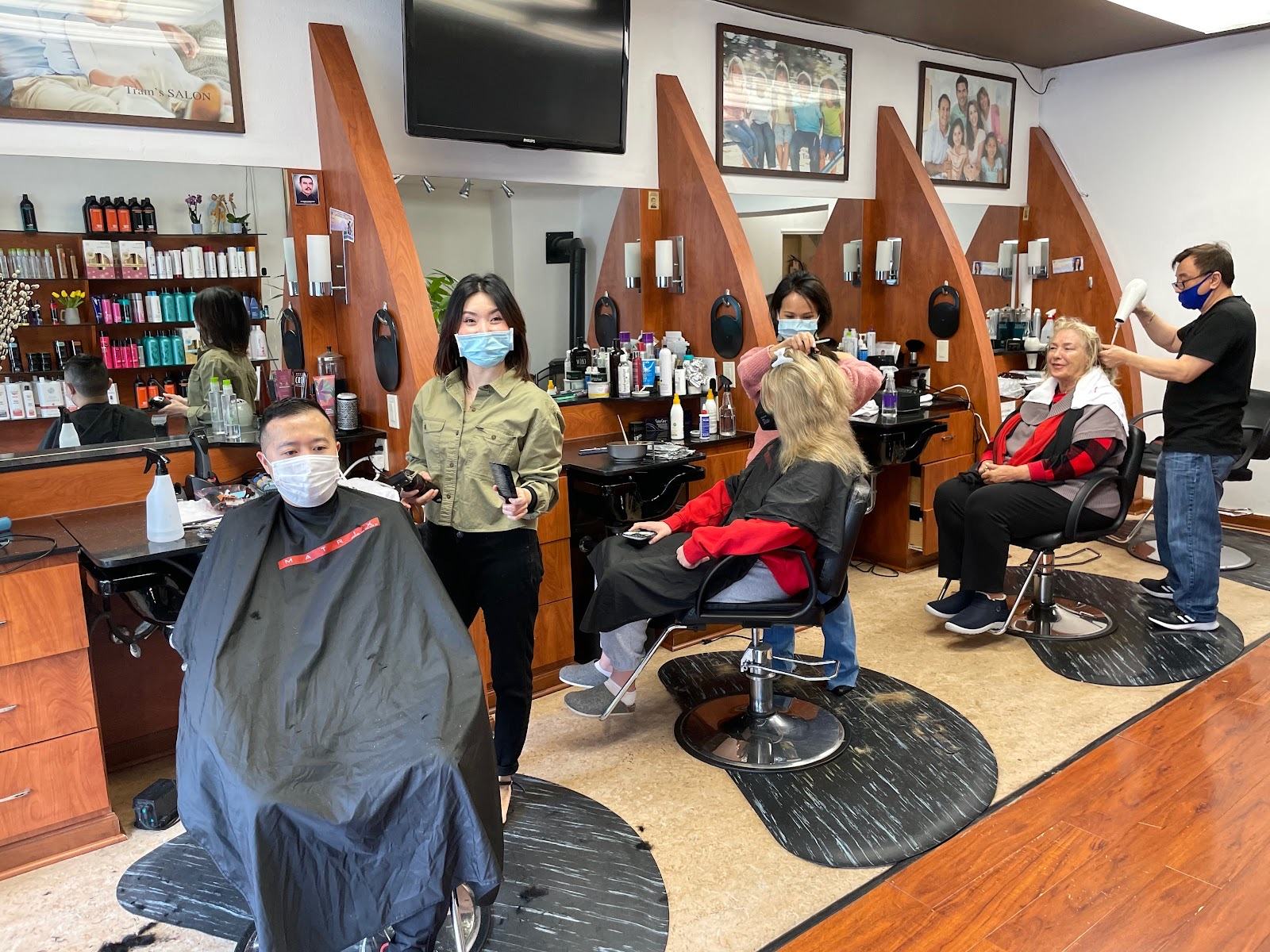 Stylists at Tram's Salon working with clients at the styling stations