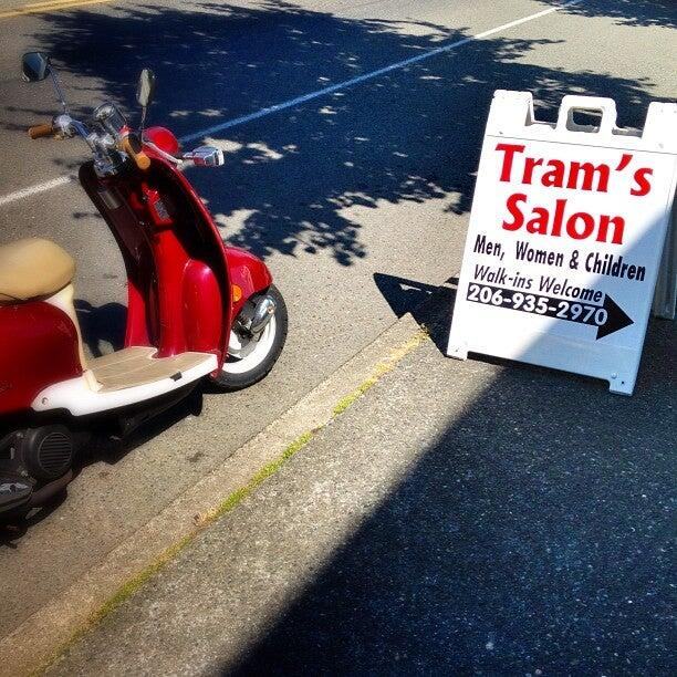 Sidewalk sign for Tram's Salon reading Men, Women and Children, Walk-ins Welcome